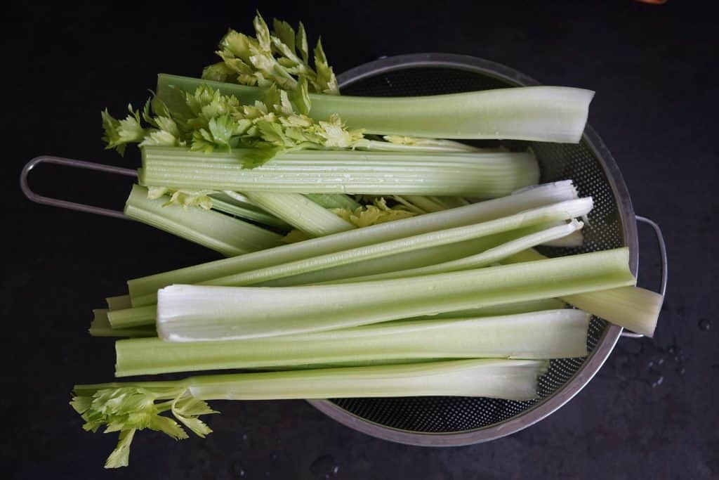 celery stalks on colander
