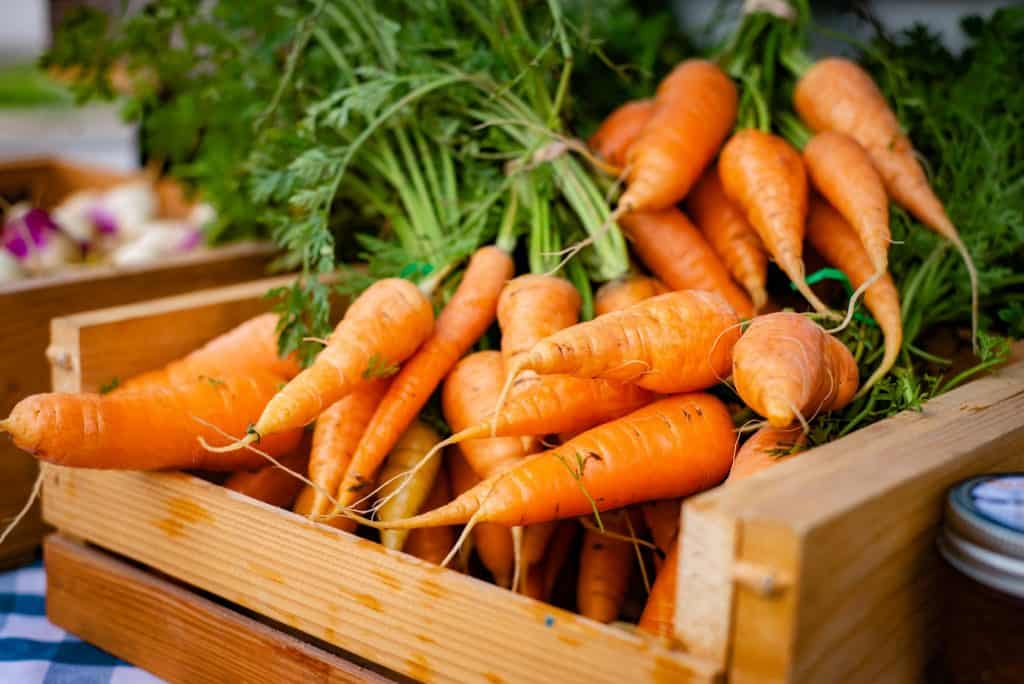 group of carrots in a wooden box