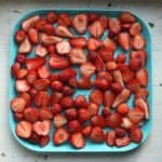 cut strawberries on baking tray