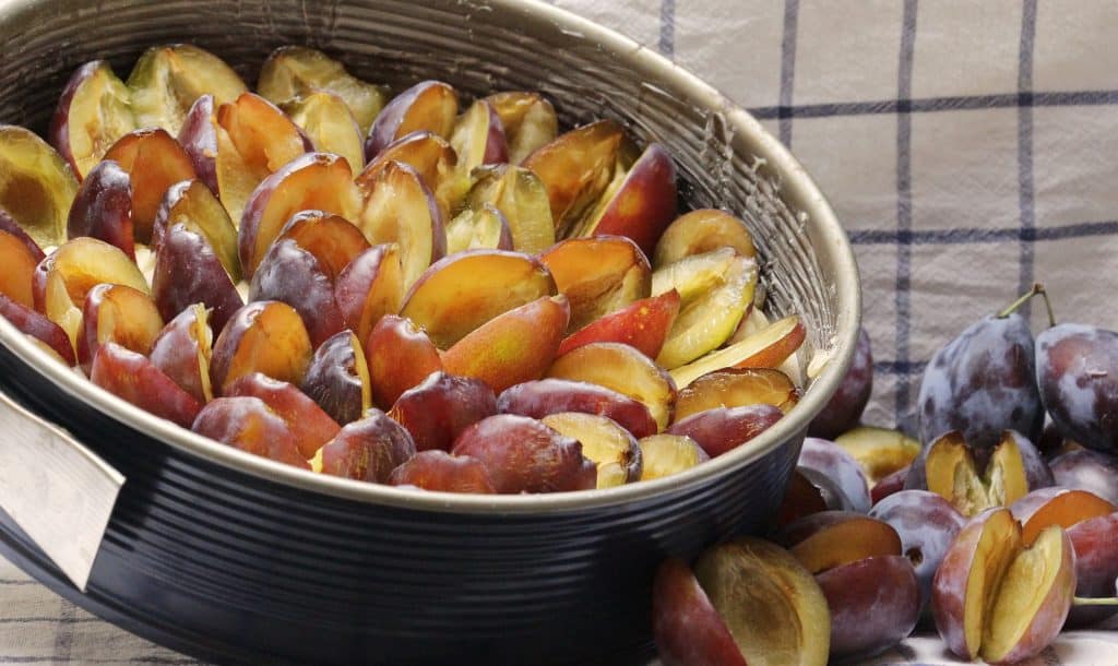 group of plums in metal container