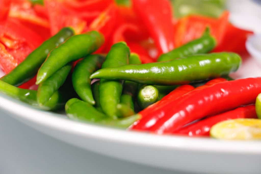 red and green jalapeno peppers on plate